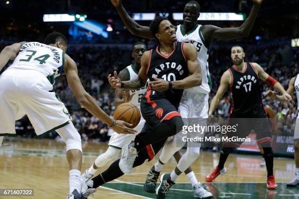 DeMar DeRozan of the Toronto Raptors gets4 stripped of the basketball by Giannis Antetokounmpo of the Milwaukee Bucks during the second half of Game...
