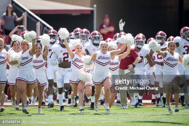 Cheerleaders for the Alabama Crimson Tide lead players out on to the field at Bryant-Denny Stadium on April 22, 2017 in Tuscaloosa, Alabama.