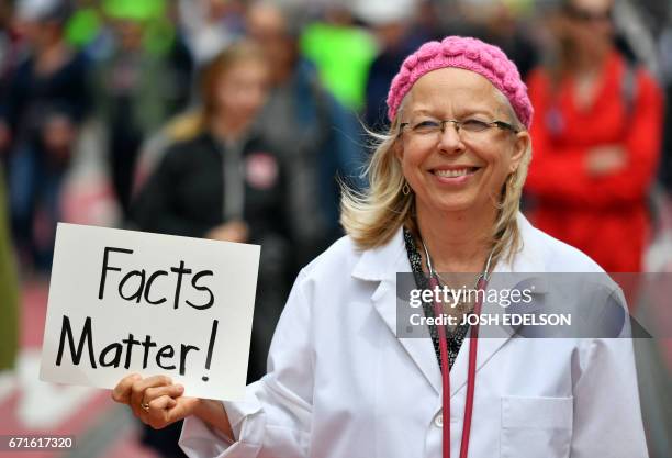 Liz Darner holds up a sign while participating in the March for Science in San Francisco, California on April 22, 2017. - Thousands of people joined...