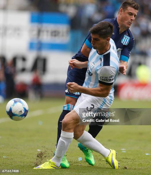 Ivan Pillud of Racing Club collides with Fernando Evangelista of Atletico de Tucuman during a match between Racing and Atletico de Tucuman as part of...