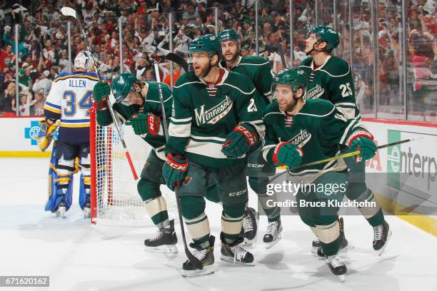 Erik Haula, Jason Pominville, Marco Scandella, Jason Zucker, and Jonas Brodin of the Minnesota Wild celebrate after scoring a goal against the St....