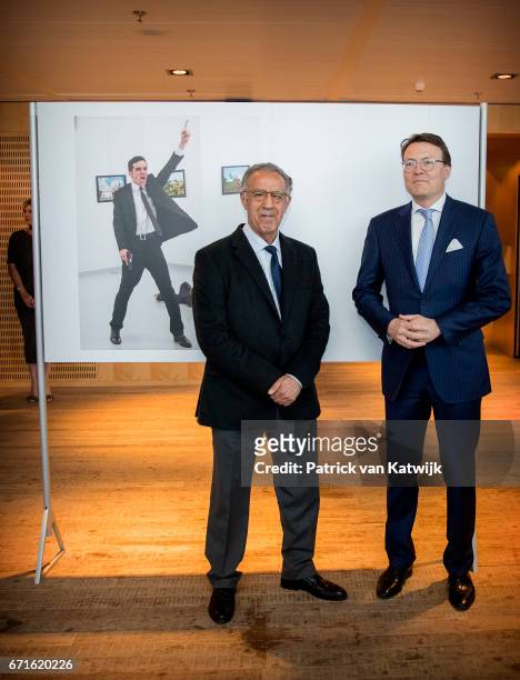 Prince Constantijn of The Netherlands with Turkish AP photographer Burhan Ozbilici pose with the World Press Photo winning picture of the murder of...