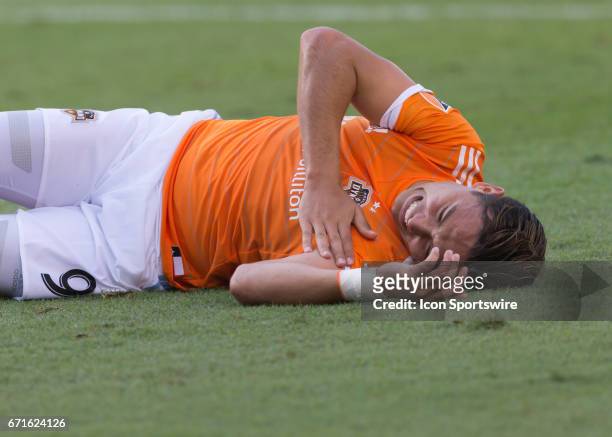 Houston Dynamo forward Erick Torres holds his left side after being tackled in the second half of the MLS match between San Jose Earthquakes and...