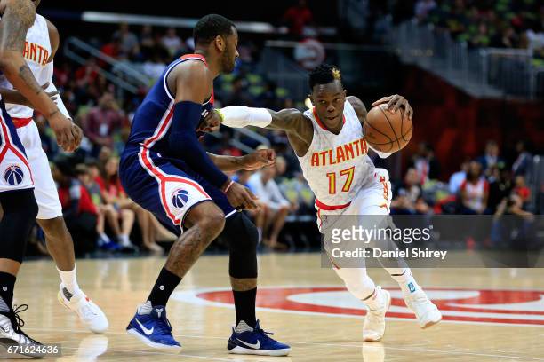 Dennis Schroder of the Atlanta Hawks drives to the basket past John Wall of the Washington Wizards during the first quarter in Game Three of the...