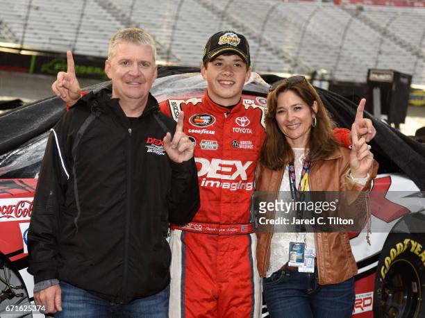 Harrison Burton, driver of the Dex Imaging Toyota, poses for a photo with his father, Jeff Burton, and mother, Kim Burton, after winning the NASCAR...