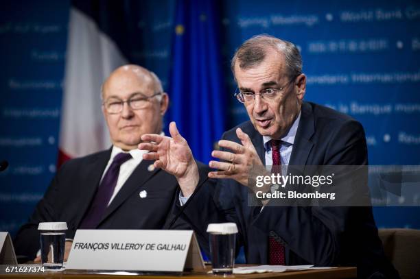 Francois Villeroy de Galhau, governor of the Bank of France, right, speaks as Michel Sapin, France's finance minister, listens during a press...