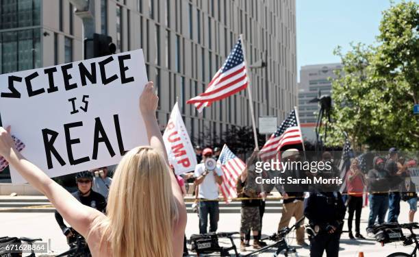 Woman is seen demonstrating in front of a small pro-Trump counter demonstration as scientists and supporters participate in a March for Science on...