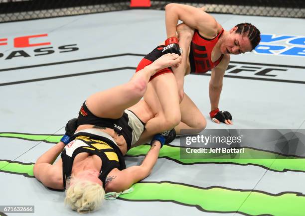 Alexis Davis of the Canada attempts to secure a leg lock against Cindy Dandois of Belgium in their women's bantamweight bout during the UFC Fight...