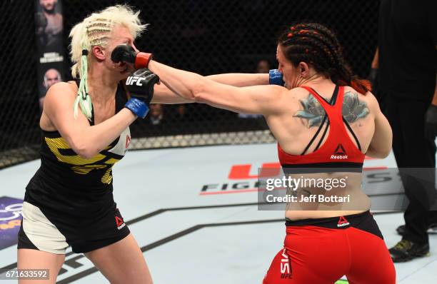 Alexis Davis of the Canada and Cindy Dandois of Belgium trade punches in their women's bantamweight bout during the UFC Fight Night event at...