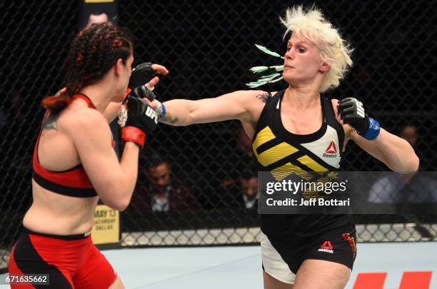 Cindy Dandois of Belgium punches Alexis Davis of the Canada in their women's bantamweight bout during the UFC Fight Night event at Bridgestone Arena...