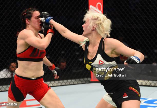 Cindy Dandois of Belgium punches Alexis Davis of the Canada in their women's bantamweight bout during the UFC Fight Night event at Bridgestone Arena...