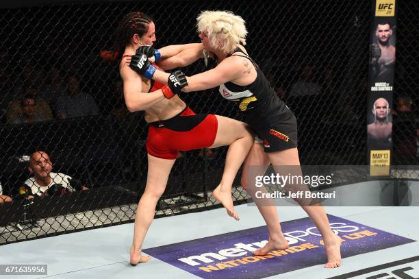 Alexis Davis knees Cindy Dandois of Belgium in their women's bantamweight bout during the UFC Fight Night event at Bridgestone Arena on April 22,...