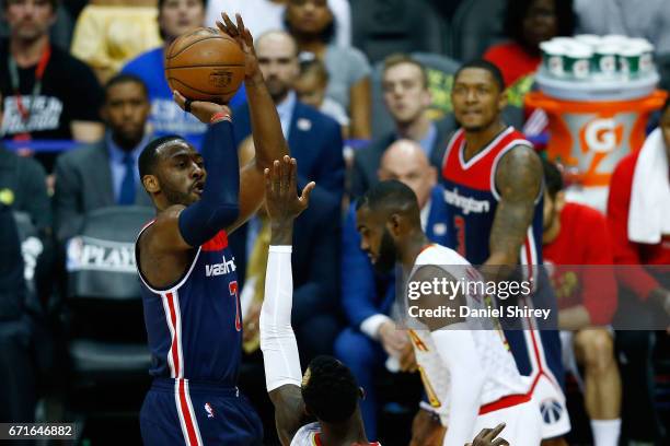 John Wall of the Washington Wizards shoots a basket over Dennis Schroder of the Atlanta Hawks during the third quarter in Game Three of the Eastern...