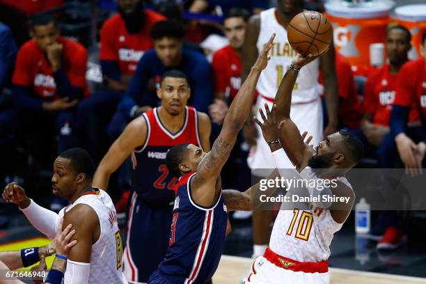 Tim Hardaway Jr. #10 of the Atlanta Hawks shoots a basket over Bradley Beal of the Washington Wizards during the third quarter in Game Three of the...