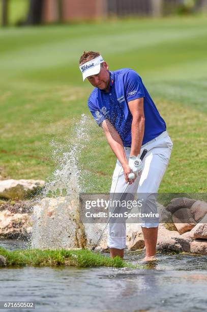 Ian Poulter hits a shot out of the hazard during the second round of the Valero Texas Open at the TPC San Antonio Oaks Course in San Antonio, TX on...