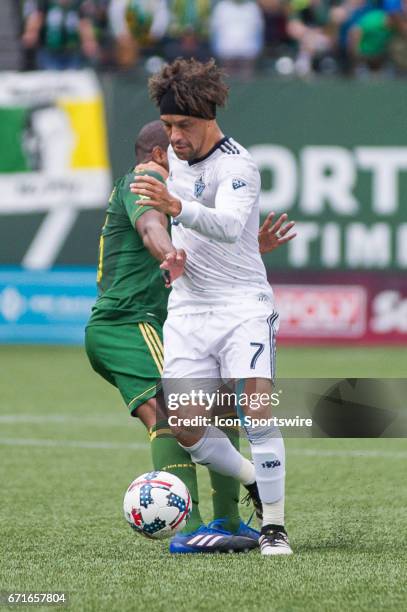 Vancouver Whitecaps midfielder Christian Bolaños dribbles past Portland Timbers midfielder Darlington Nagbe during the Portland Timbers home victory...