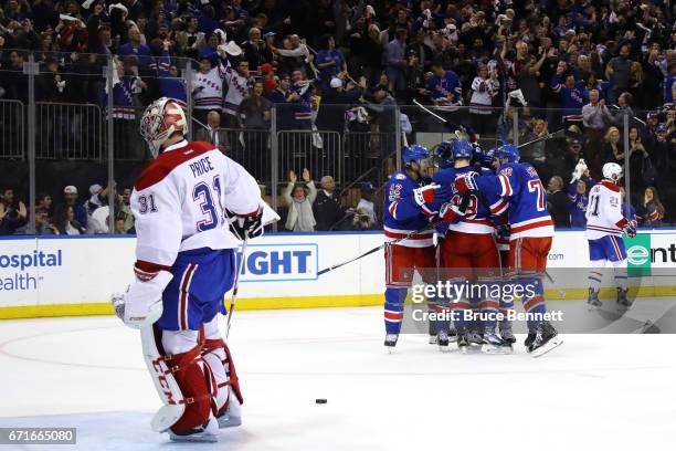 Mats Zuccarello of the New York Rangers celebrates with his teammates after scoring his second goal against Carey Price of the Montreal Canadiens...