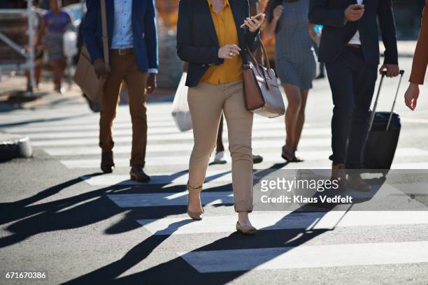 business people walking on pedestrian crossing - fußgänger stock-fotos und bilder