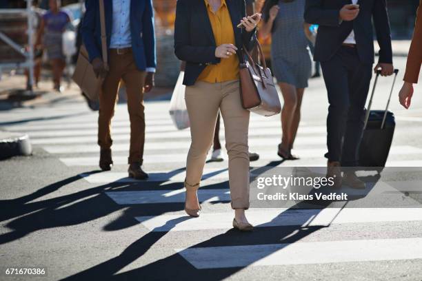 business people walking on pedestrian crossing - pedestrian stock pictures, royalty-free photos & images