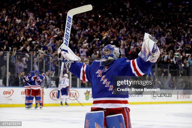 Henrik Lundqvist of the New York Rangers celebrates teammate Derek Stepan empty net goal against the Montreal Canadiens during the third period in...