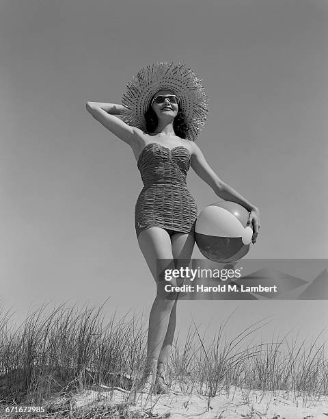 Girl With Watering Can Standing On Beach.