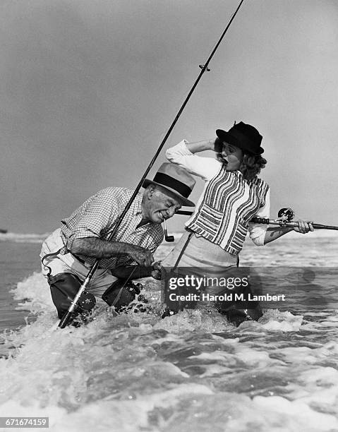 Senior Man Clinging Fishing Hook On WomanS Pant.