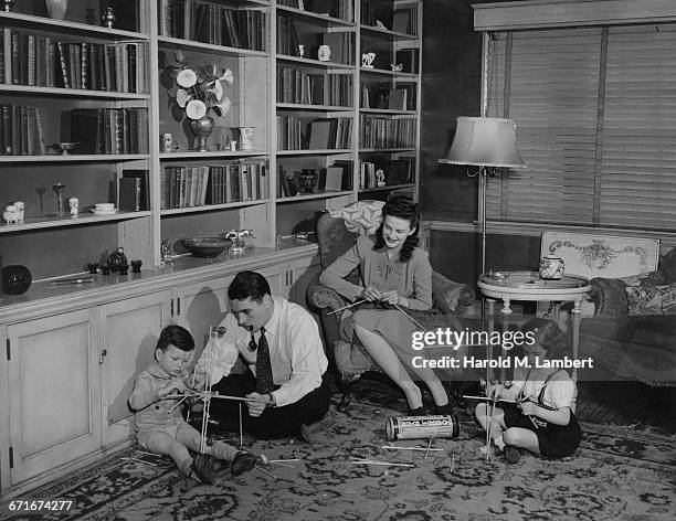 Parents Helping Their Children In Their Project.