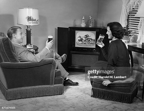 Couple Drinking Wine In Living Room.