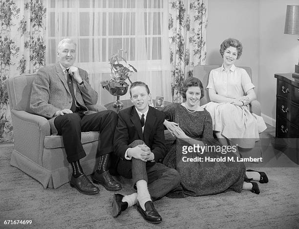 Portrait Of Family Sitting In Living Room.