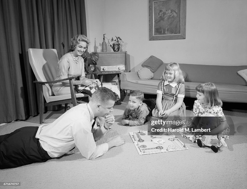  Father Playing With Kid While Mother Sitting In Living Room