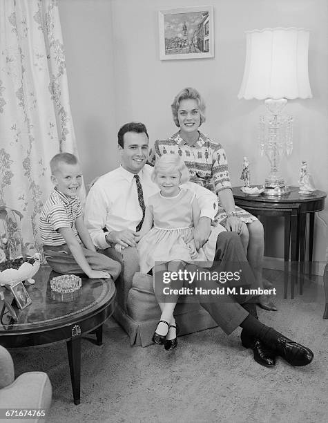 Family Sitting In Living Room.