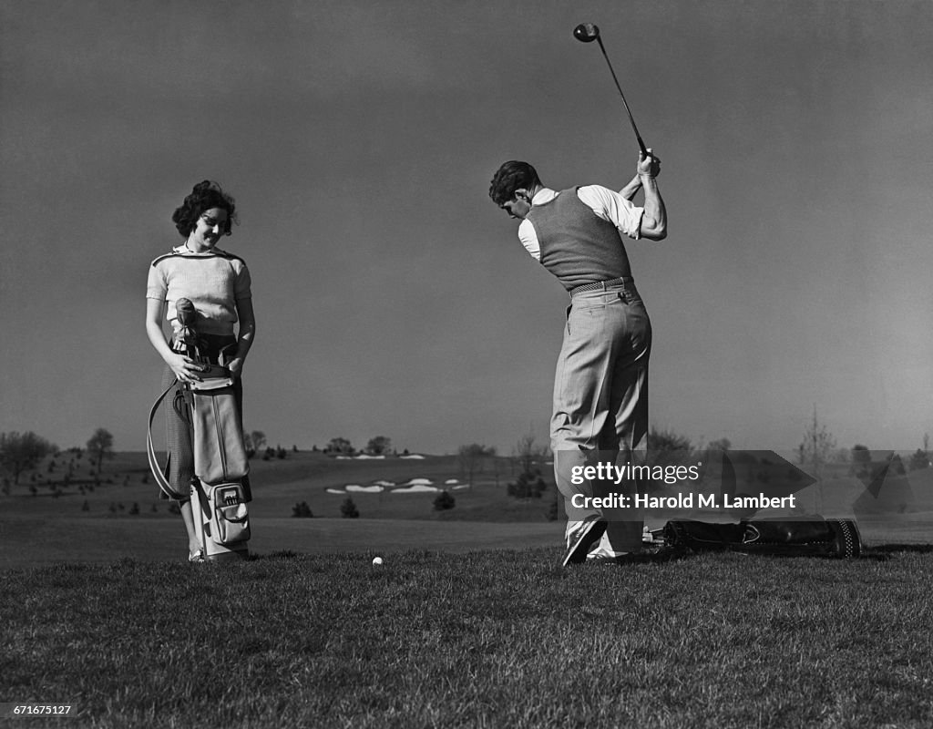   Man And Woman Playing Golf 