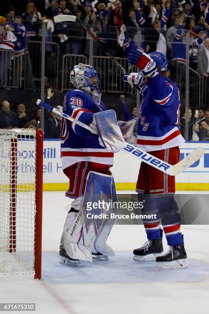 Henrik Lundqvist of the New York Rangers celebrates with teammate Marc Staal after defeating the Montreal Canadiens in Game Six of the Eastern...