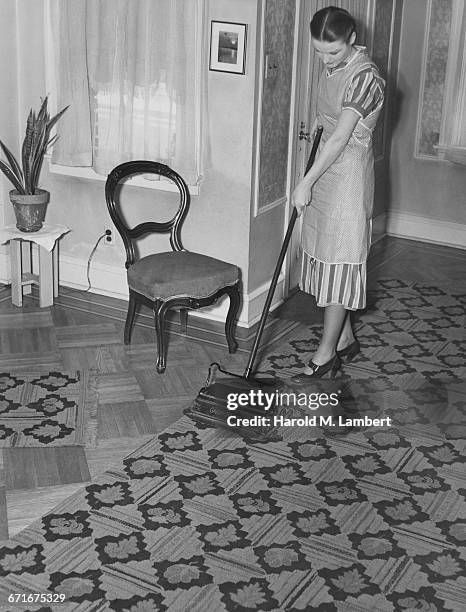 Young Woman Cleaning Floor With Scrub Brush .