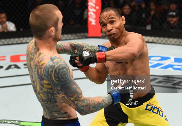 Eddie Wineland punches John Dodson in their bantamweight bout during the UFC Fight Night event at Bridgestone Arena on April 22, 2017 in Nashville,...