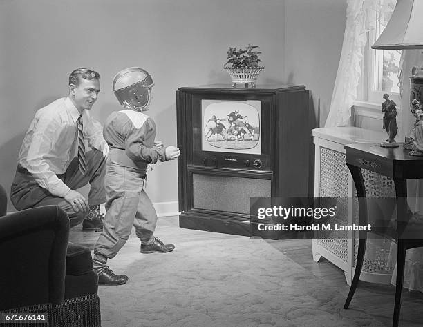 Boy And Father Watching Television.