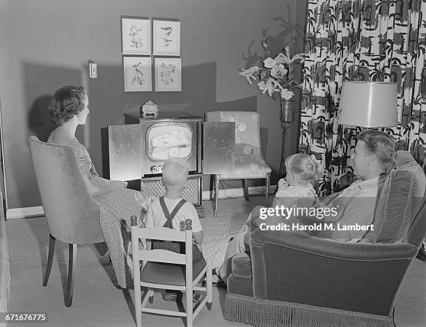 Family Watching Television In Living Room .
