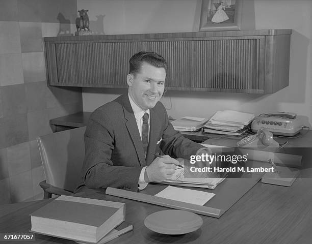 " Portrait Of Businessman In Office, Smiling. "