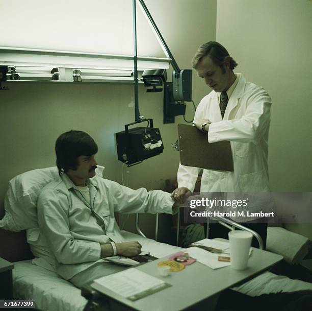 Doctor Checking Pulse Of Man .