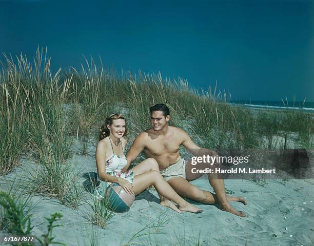 Young Couple Relaxing On Beach .