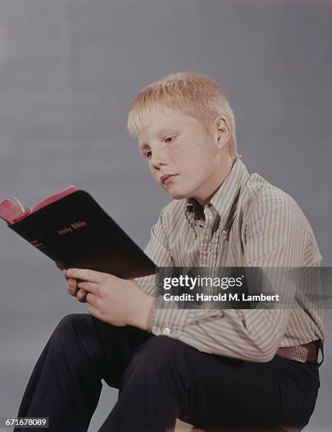 Boy Reading Scriptures Boy Reading The Bible Photos and Premium High Res Pictures - Getty Images