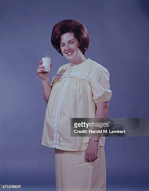 Pregnant Woman Holding Glass Of Milk.
