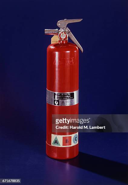 Close-Up Of Fire Extinguisher Against Blue Background .