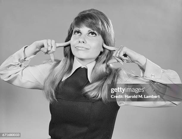 " Young Woman With Fingers In Ears, Close-Up. "