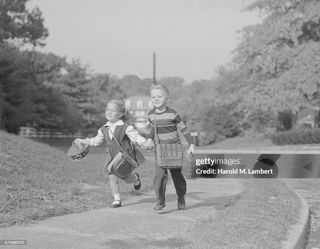  Boy And Girl Running With Book