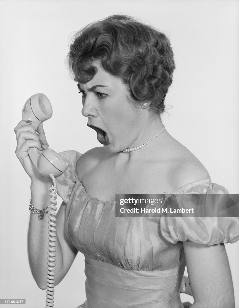 Studio Shot Of Beautiful Woman Shouting On Phone