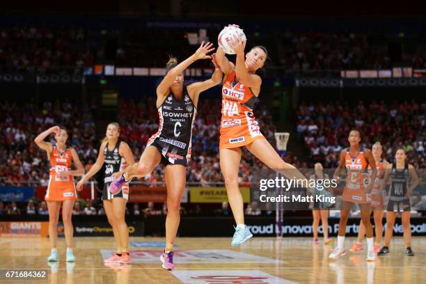 Taylah Davies of the Giants is challenged by Kim Ravaillion of the Magpies during the round nine Super Netball match between the Giants and the...