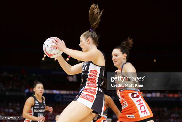 Alice Teague-Neeld of the Magpies is challenged by Sam Poolman of the Giants during the round nine Super Netball match between the Giants and the...