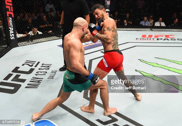 Artem Lobov of Russia punches Cub Swanson in their featherweight bout during the UFC Fight Night event at Bridgestone Arena on April 22, 2017 in...