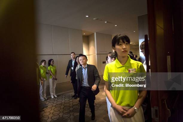 Billionaire Jack Ma, chairman of Alibaba Group Holding Ltd., center left, arrives at a session at the China Green Companies Summit in Zhengzhou,...